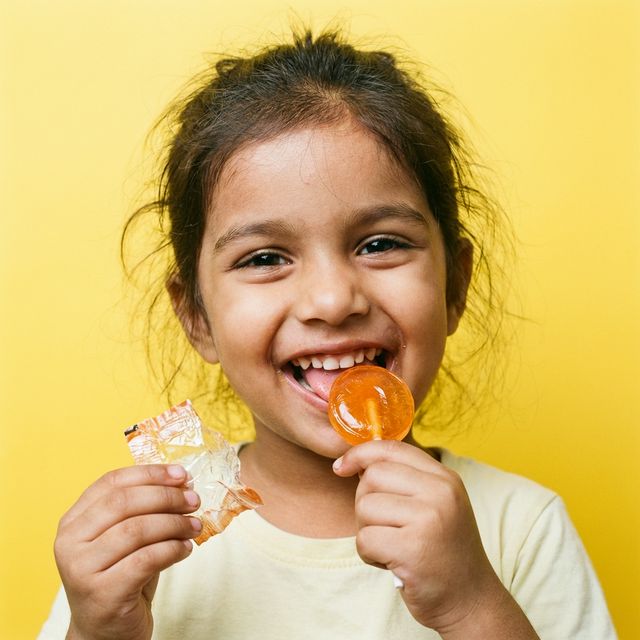 Happy child eating candy